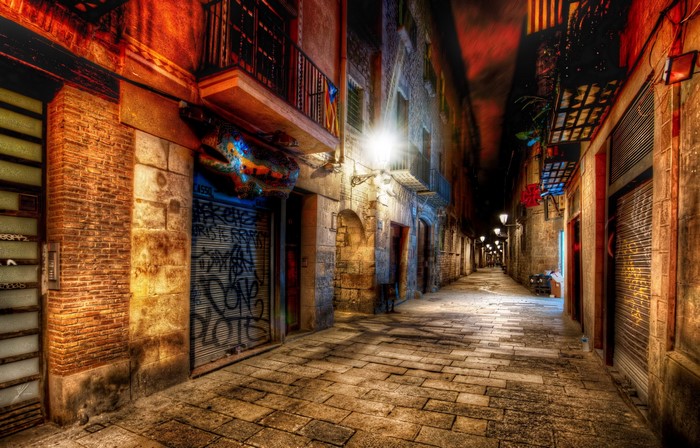 Nighttime street in Barcelona with graffiti and street lights