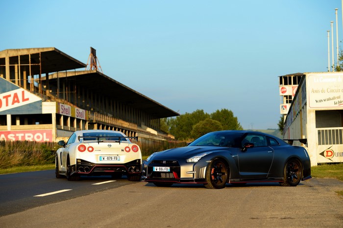 Two Nissan GT-R Nismo cars on a racetrack