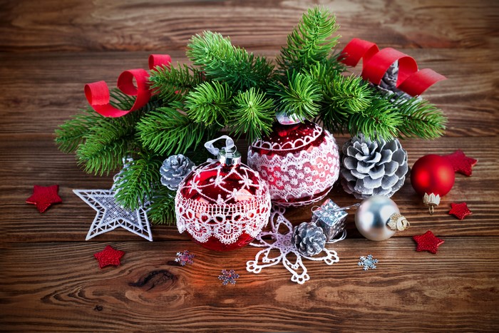Christmas ornaments and pine cones on wooden background