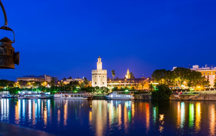 Torre del Oro and Guadalquivir River at Night in Seville, Spain