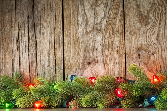 Christmas Branches with Fairy Lights on Wood