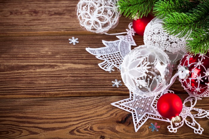 Christmas ornaments and fir branch on wooden background
