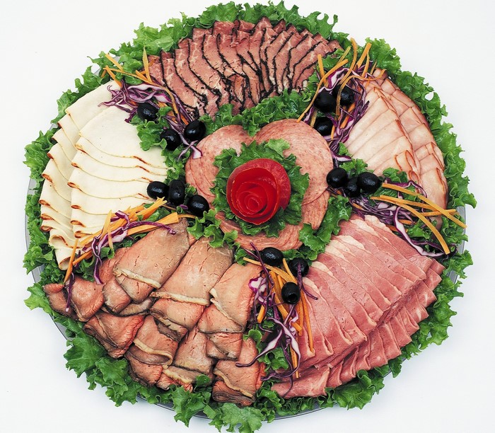 Assorted deli meats platter with lettuce and olives