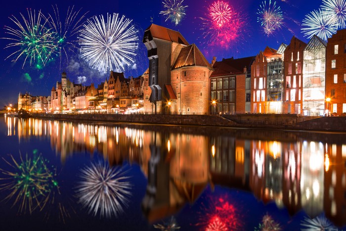 Fireworks over Gdańsk waterfront at night