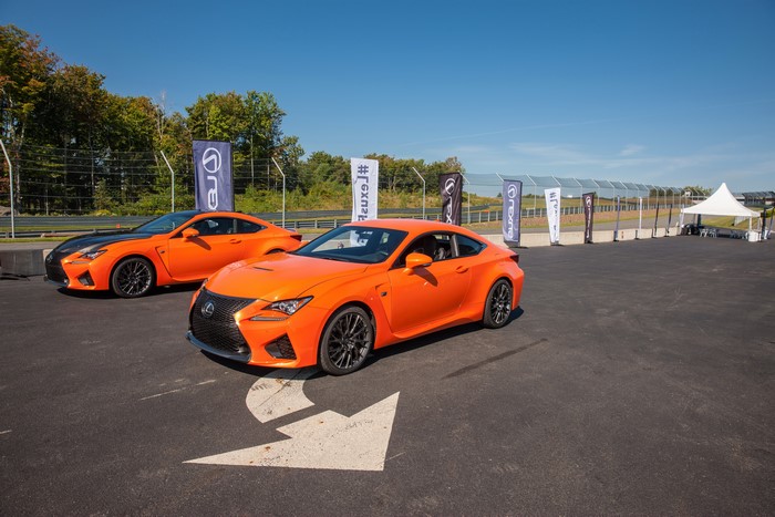Two orange Lexus RC F cars on a track
