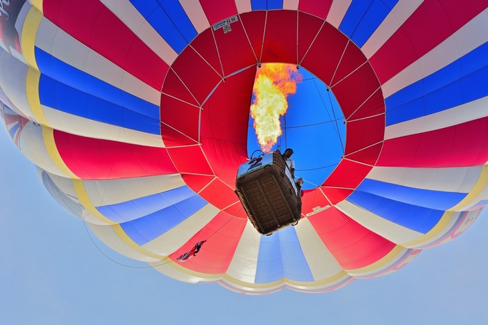 Hot air balloon with flame and basket