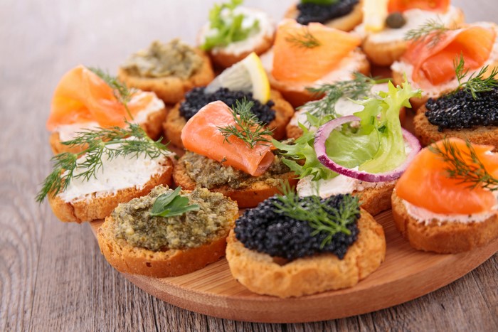 Assorted canapés with salmon, caviar, and spreads