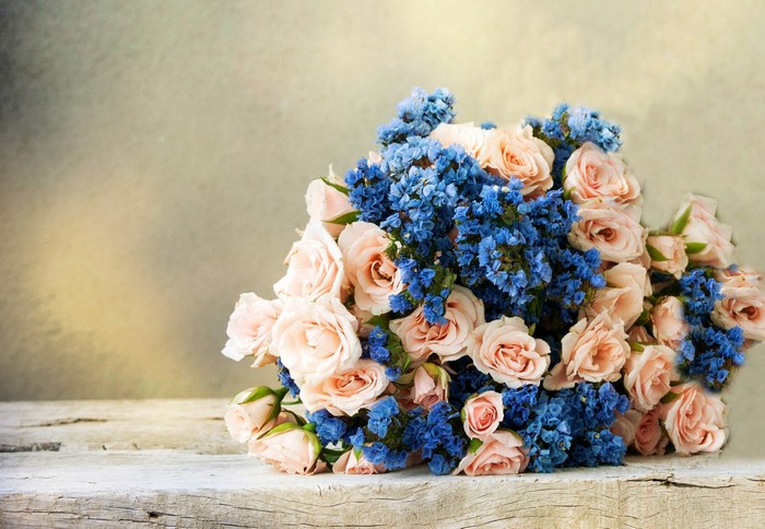 Bouquet of pink roses and blue delphinium flowers