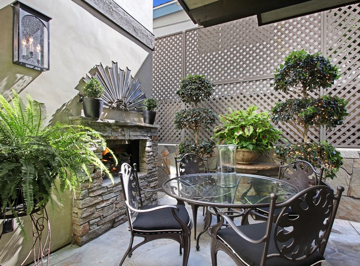 Outdoor Patio with Fireplace, Table, and Chairs