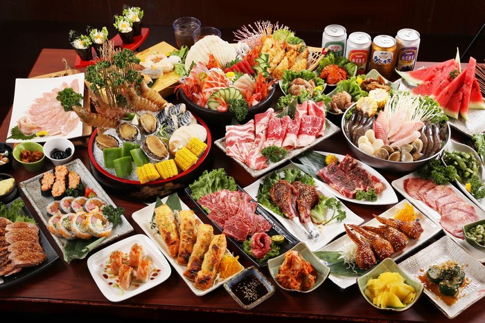 Assortment of Japanese Food: Sushi, Sashimi, Grilled Meats, and Seafood
