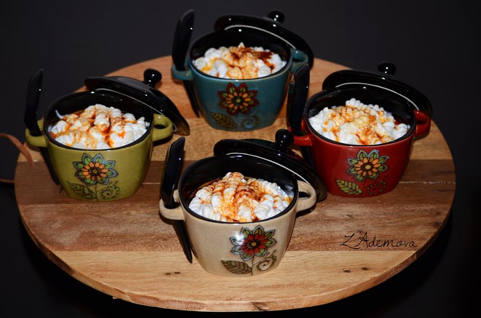Four decorative bowls of pasta with red sauce