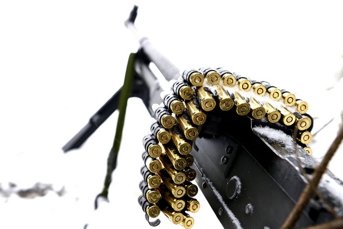 Machine gun with ammunition belt in snow