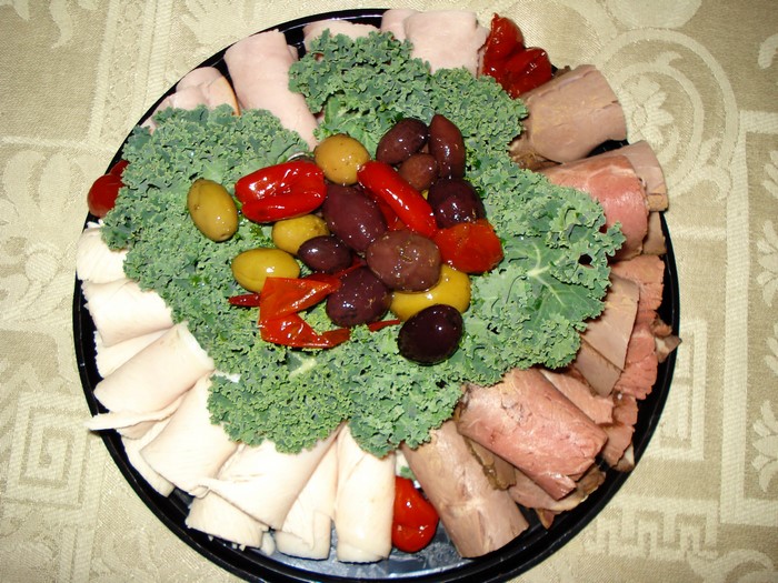 Meat and cheese platter with olives and peppers