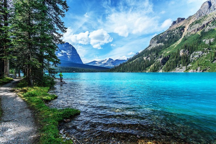 Turquoise lake with mountains and pine trees