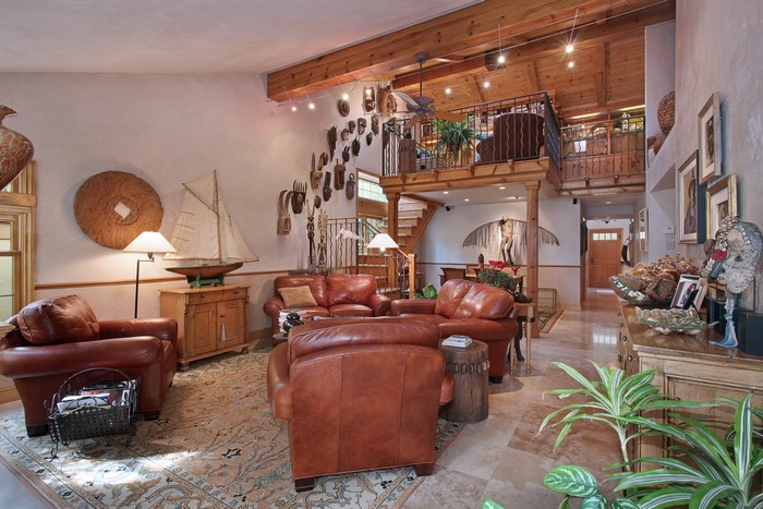 Living room interior with leather armchairs and loft