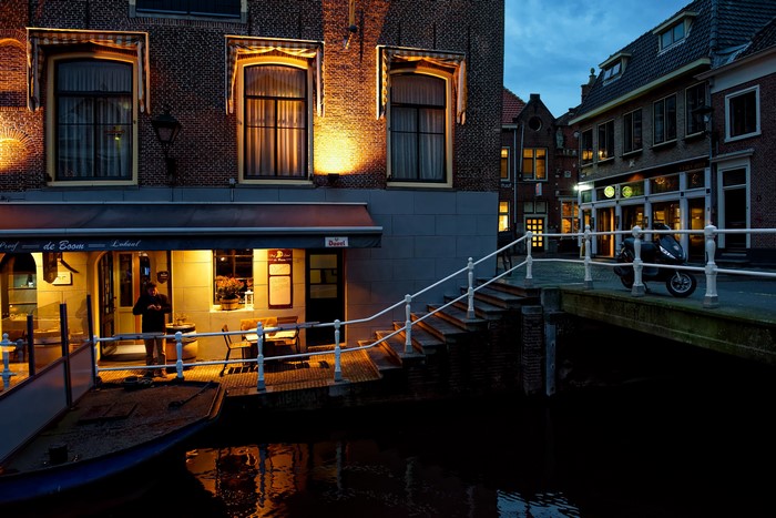 Canal-side restaurant and bridge in Alkmaar at night