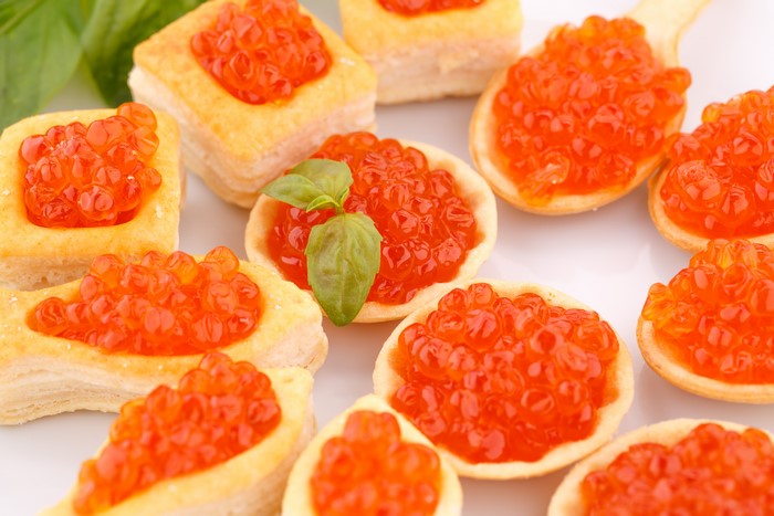 Red Caviar Appetizers on Puff Pastry and Spoons