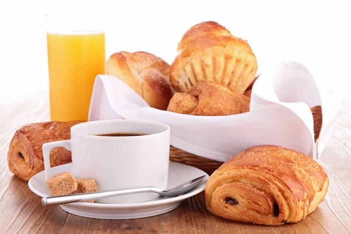 Breakfast with coffee, juice, and pastries