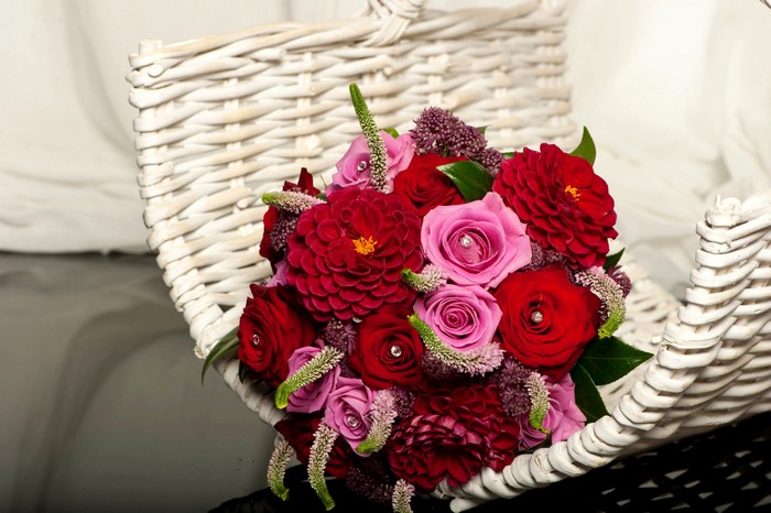 Bouquet of Red and Pink Roses and Dahlias in a White Basket
