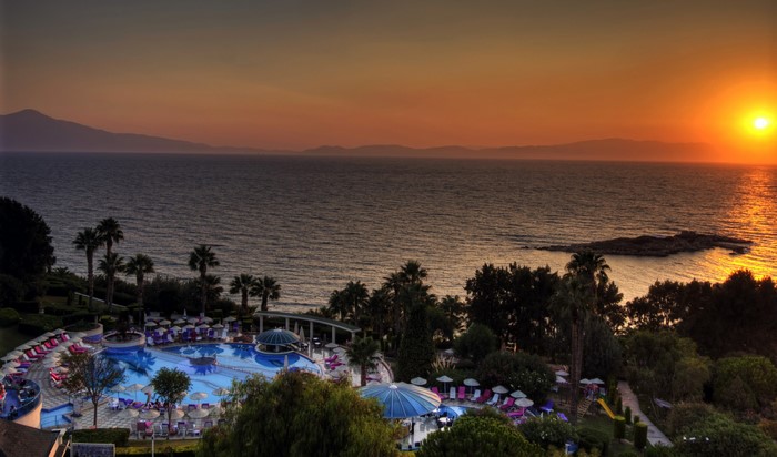 Resort pool and coastline at sunset in Kusadasi, Turkey