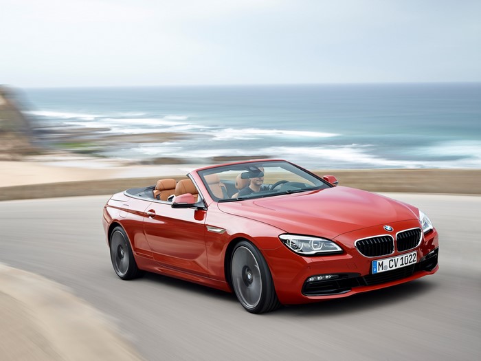 Red 2015 BMW M6 Cabriolet driving by the ocean
