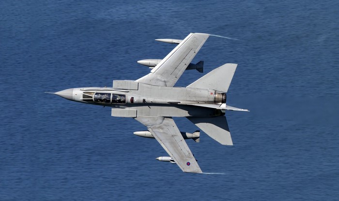 Fighter jet flying over the ocean