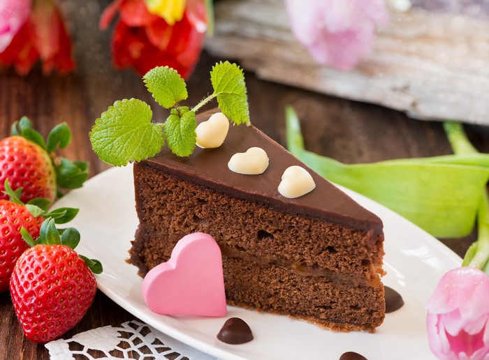 Slice of Chocolate Cake with Strawberries and Flowers