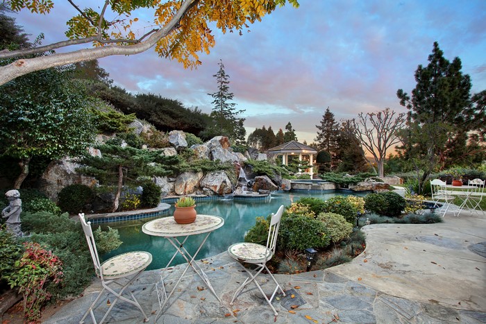 Backyard pool with waterfall and gazebo in San Juan Capistrano