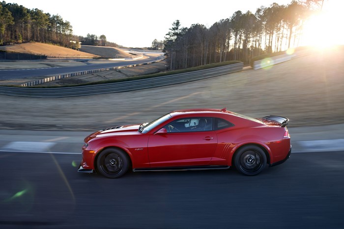Red 2015 Chevrolet Camaro Z28 on a race track