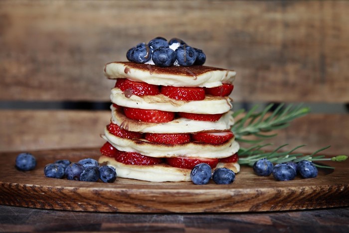 Stack of pancakes with strawberries and blueberries