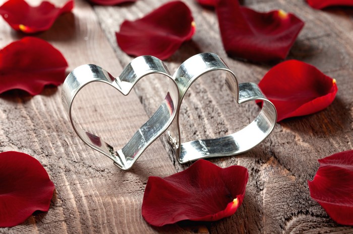 Two heart cookie cutters with rose petals