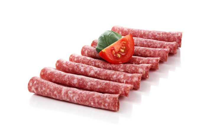 Sausages with tomato and basil on a white background