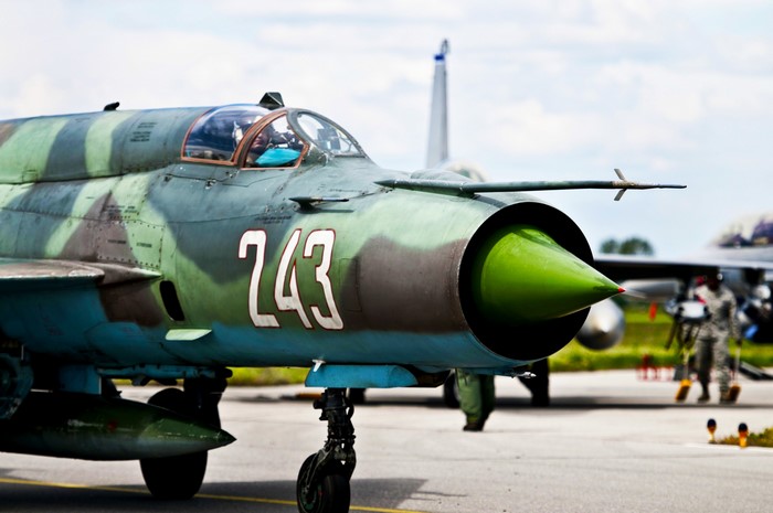 Camouflaged fighter jet with number 243