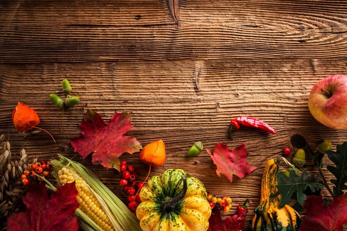 Autumn Harvest Display with Pumpkins, Corn, and Apples
