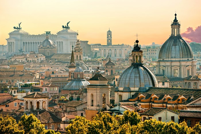 Rome cityscape with domes and monuments at sunset