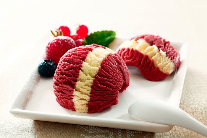 Red and white ice cream scoops with berries