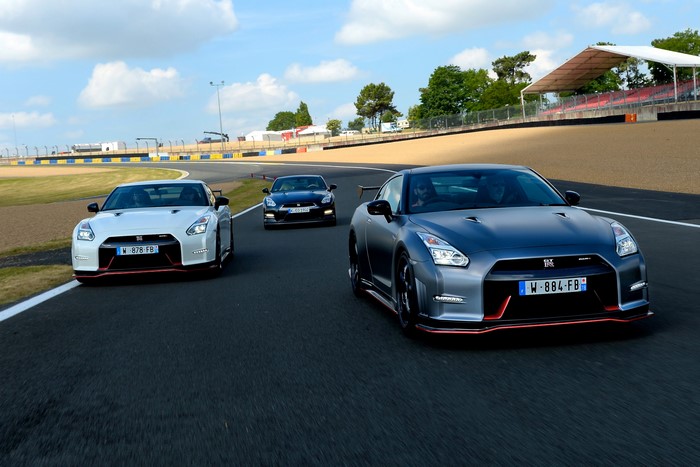 Three Nissan GT-R Nismo cars on a race track