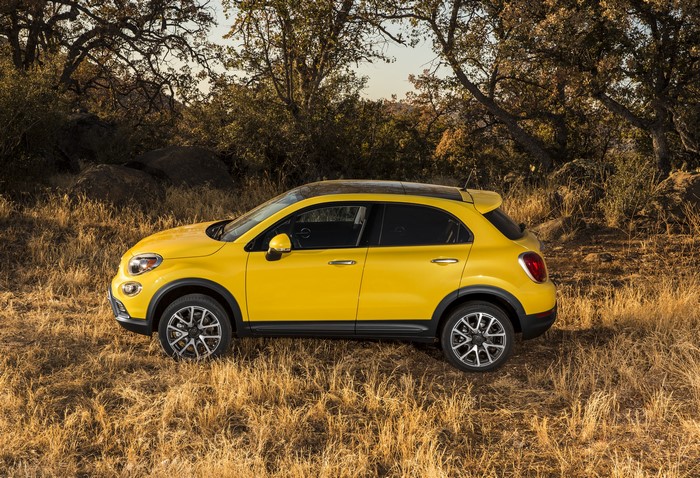 Yellow Fiat 500X Trekking Plus parked on dry grass