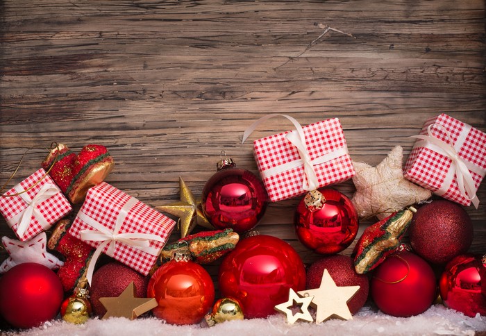 Christmas ornaments and gifts on wooden background