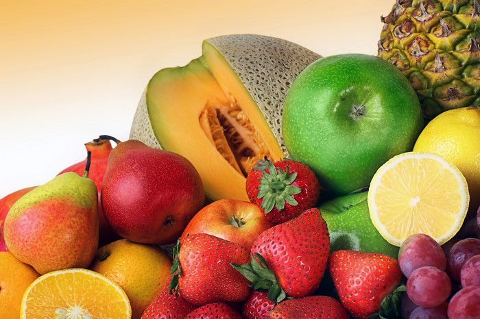 Assortment of fresh fruits including apples, pears, strawberries, and melon