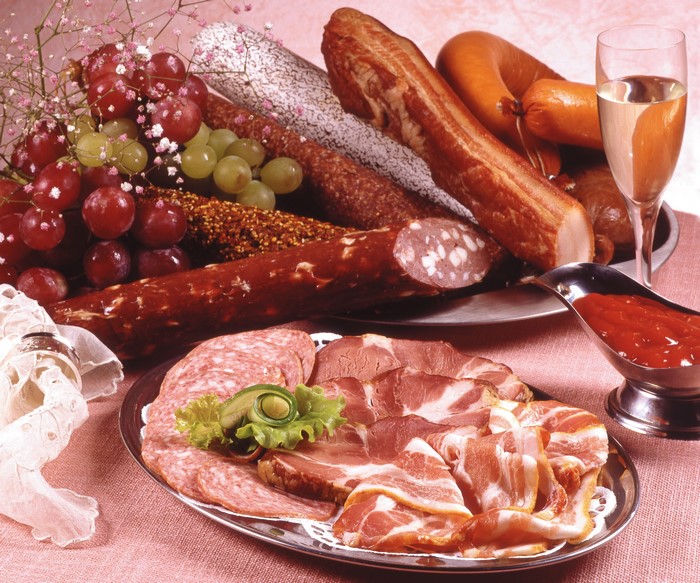 Assortment of cured meats, grapes, wine, and ketchup