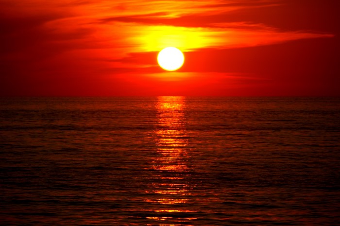 Sunset over the ocean with reflection