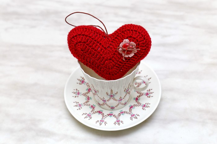 Red crocheted heart in a teacup