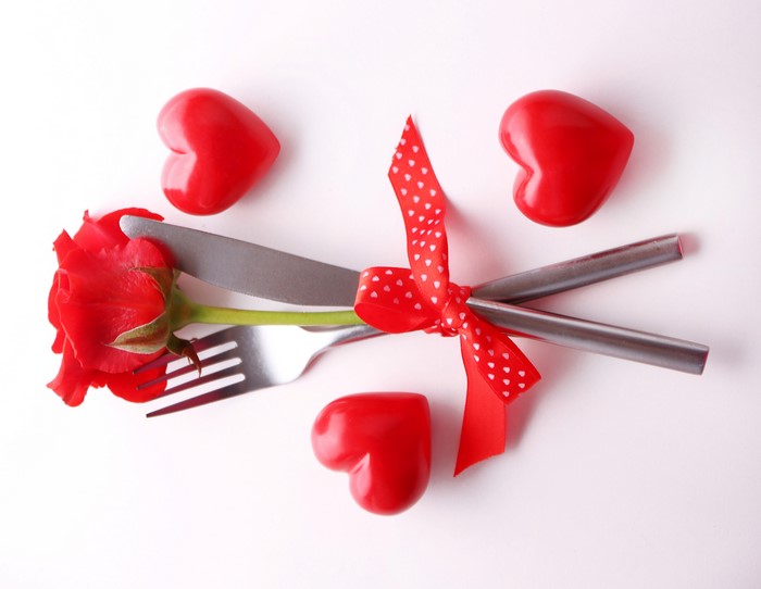Valentine's Day Table Setting with Rose, Cutlery, and Hearts