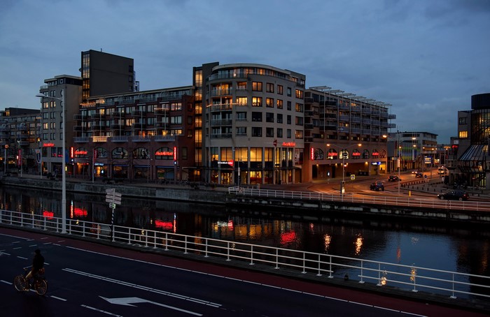 Apartment buildings and river at night in Alkmaar, Netherlands