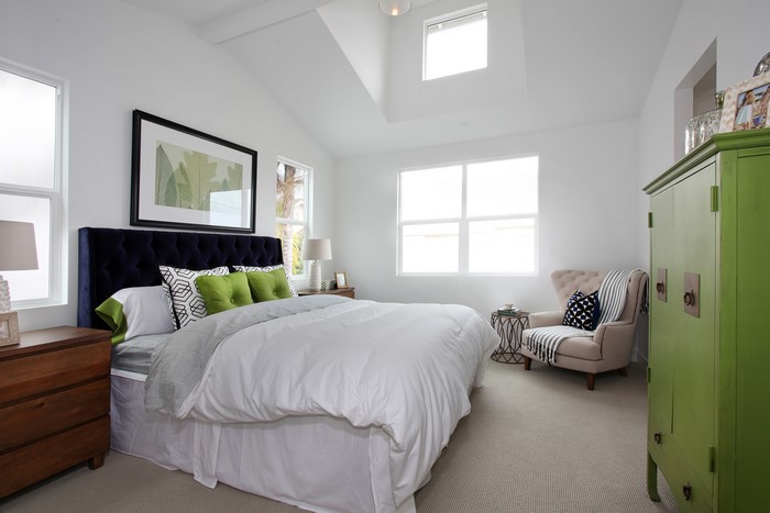 Bedroom with bed, dresser, and green cabinet