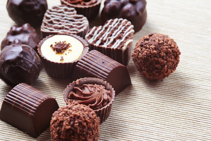 Assortment of chocolates on a textured surface