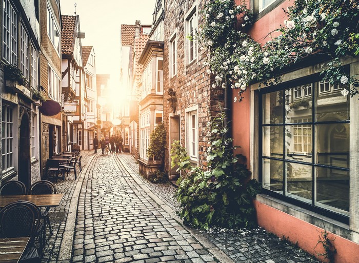 Cobblestone street with buildings and outdoor seating