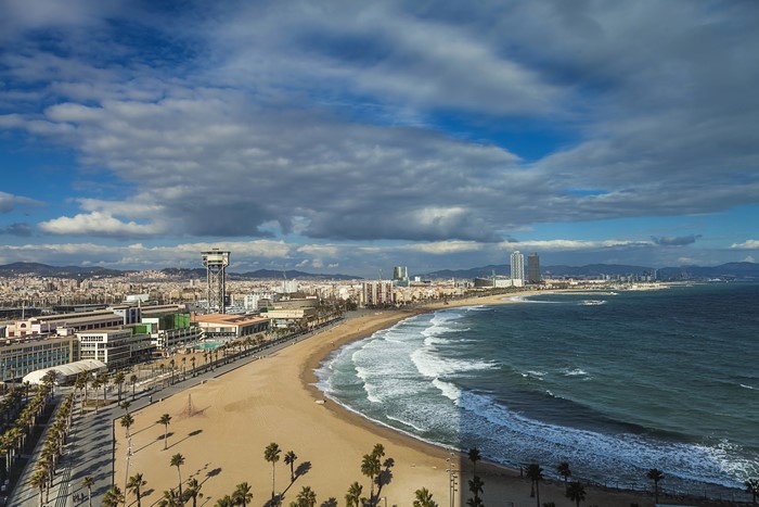 Barcelona beach and cityscape with cloudy sky