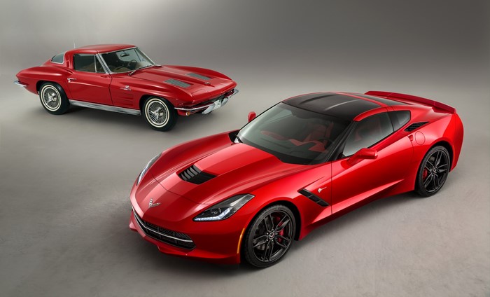 Two red Chevrolet Corvettes, classic and modern